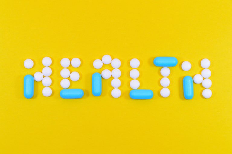 Pills arranged to spell health