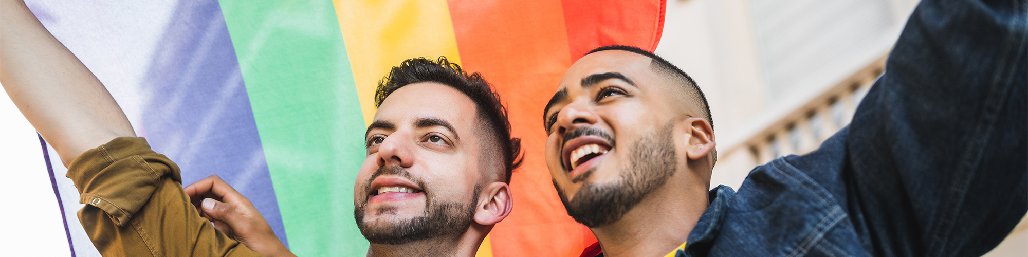 Two young men with a pride flag