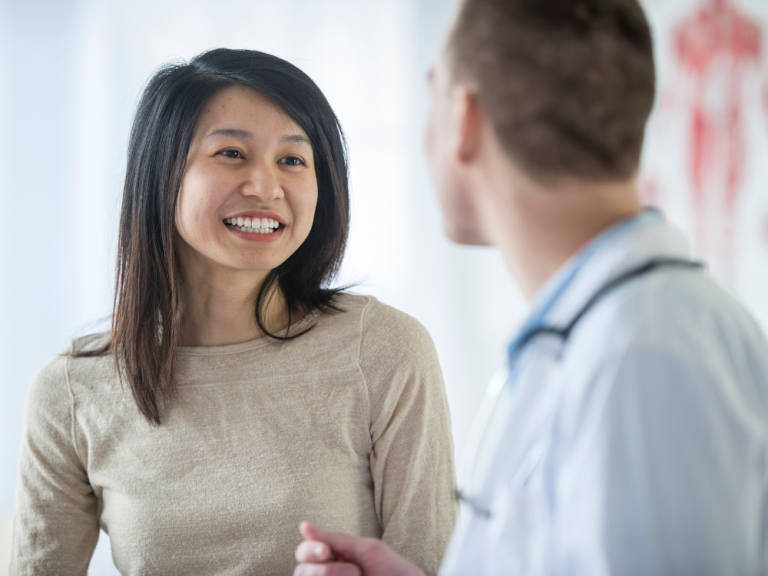 Young woman chatting with doctor