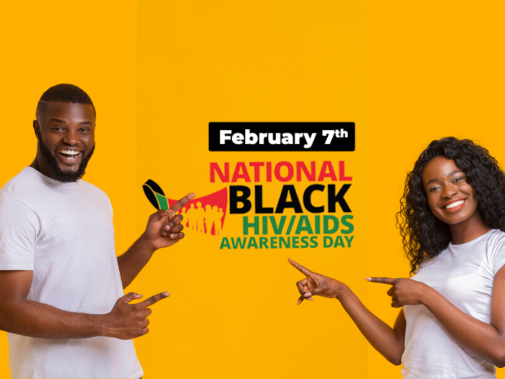 Young African American man and woman pointing at the logo for National Black HIV/AIDS Awarness Day