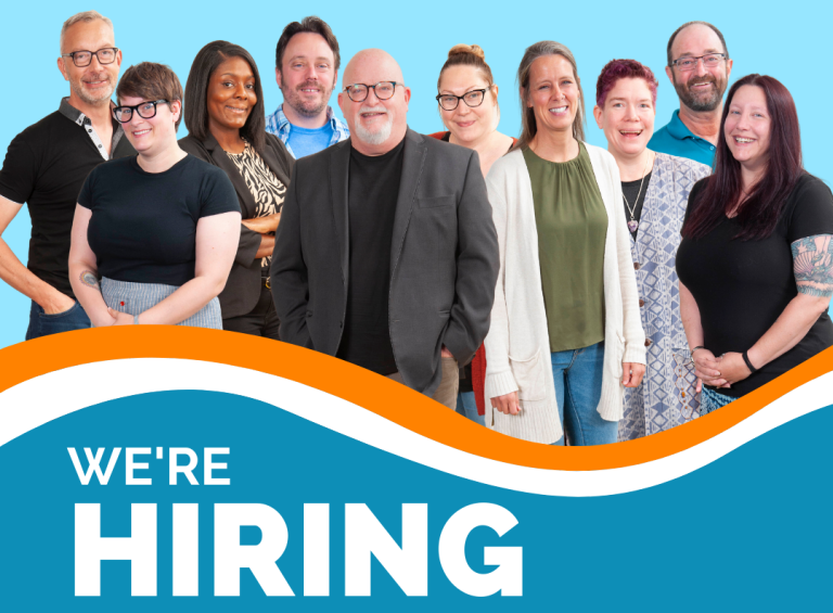 group of smiling people with the words "We're Hiring"