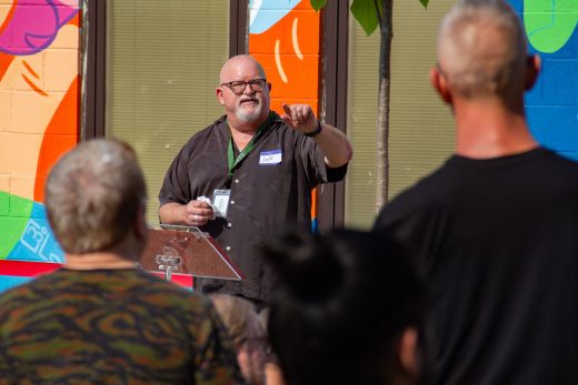 Man stands at podium addressing crowd