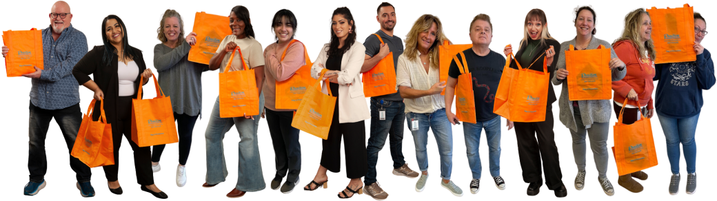 PRC staff members hold orange Bag of Prevention tote bags