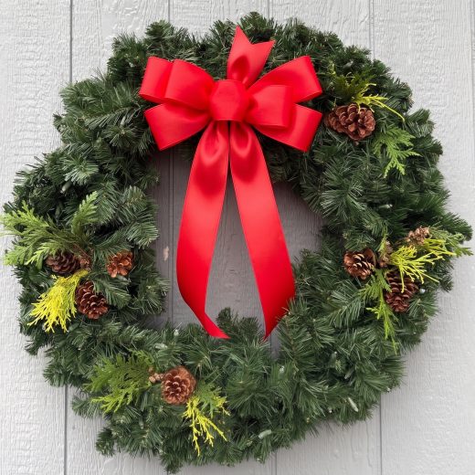 fresh green wreath with shiny red ribbon
